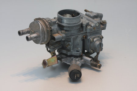 An old and used automotive carburettor isolated on white. Automatic choke and idle valve.の写真素材