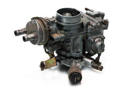 An old and used automotive carburettor isolated on white. Automatic choke and idle valve.の写真素材