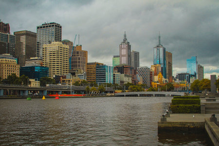 Central business district in Melbourne, Australia, looking over from Yarra river towards CBD on a cloudy day.の写真素材