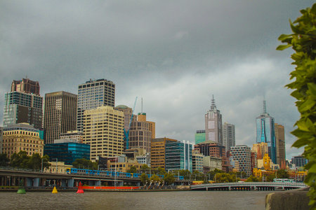 Central business district in Melbourne, Australia, looking over from Yarra river towards CBD on a cloudy day.の写真素材