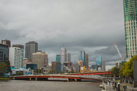 Central business district in Melbourne, Australia, looking over from Yarra river towards CBD on a cloudy day.の写真素材