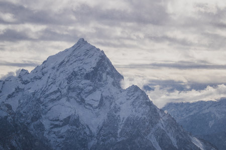 Snowy mountain peak around Cortina d'Ampezzo, Italy. View of the high peaks in dolomites on a cloudy day.の写真素材