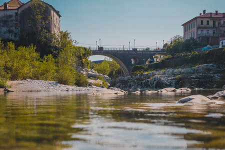 Famous bridge on Kanal ob Soci village during hot summer day with cold Soca river flowing below the bridge. Frog view of a bridge in Kanal.の写真素材