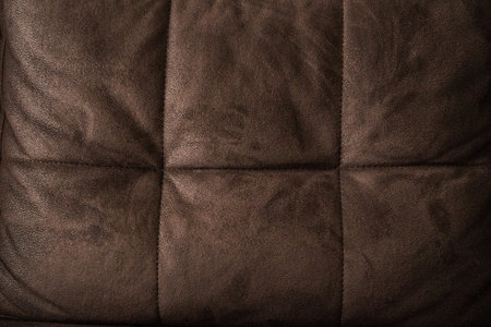 Texture of a couch headrest made out of brown leather.の写真素材