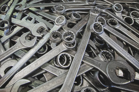 A pile of metal wrenches. A large amount of wrenches lying on each other.の写真素材