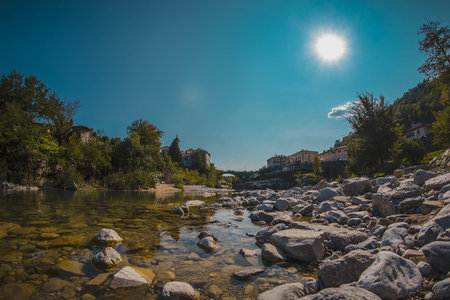 Famous bridge on Kanal ob Soci village during hot summer day with cold Soca river flowing below the...