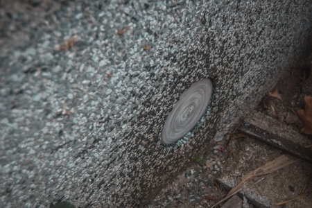 Diamant drill for making holes in the concrete exiting through drilled hole. Visible rotating drill and water.の写真素材