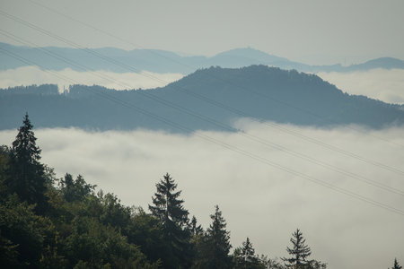 Panorama of Sava river valley at Kresnice village, viewed from a high vantage point. Dense morning fog or clouds in the valley are visible due to Sava river.の写真素材