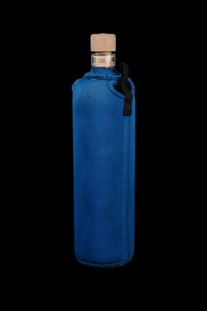 Ecological sport water bottle made of recyclable glass, cork cap and covered in blue neoprene cover for safety and insulation. Isolated on black.の写真素材