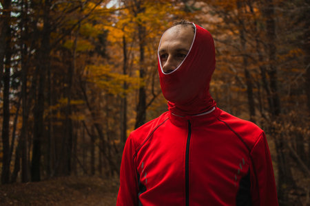 Person looking stupid in the woods with buf or head band pulled over his head just partially. Kenny style wearing of headband.の写真素材