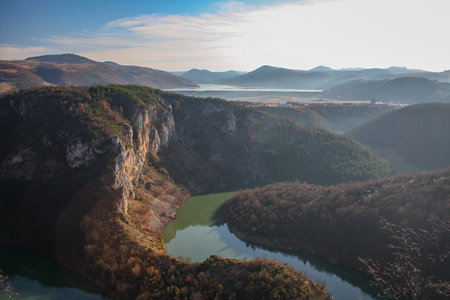 A river gorge in Zlatar region of Serbia. Hills and cloudy skies are seen in the far background.の写真素材