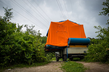 Home made camper van with a tent on the back of the rear panel. Picture of a home made adventure mobile.の写真素材