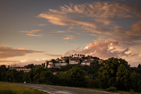 Panoramic picture of Stanjel, a gem in Karst region of Slovenia on a evening with sun lighting the colorful clouds above the village.の写真素材