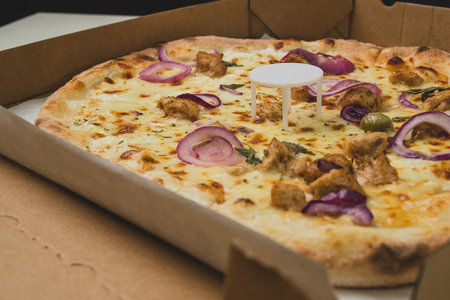 Pizza saver or ottoman, known also as pizza table, used in pizza deliveries to save the pizza being squished in a cardboard box. Tasty delicious pizza being saved by pizza saver.の写真素材