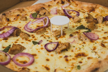 Pizza saver or ottoman, known also as pizza table, used in pizza deliveries to save the pizza being squished in a cardboard box. Tasty delicious pizza being saved by pizza saver.の写真素材
