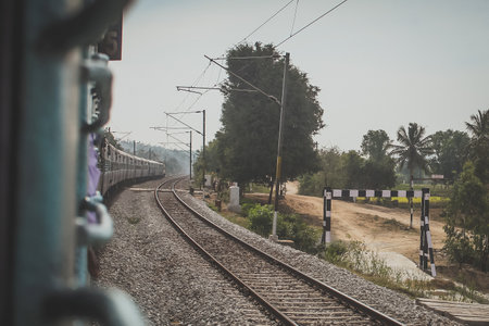 Riding on a traditional indian train, looking out towards the nature and second track.の写真素材