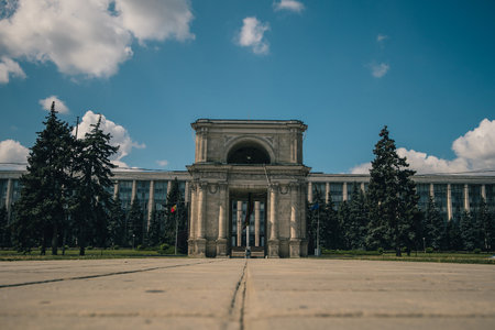 The Triumphal Arch in front of the Government building in Chisinau, Moldova on a warm summer day. Frog view photoの写真素材