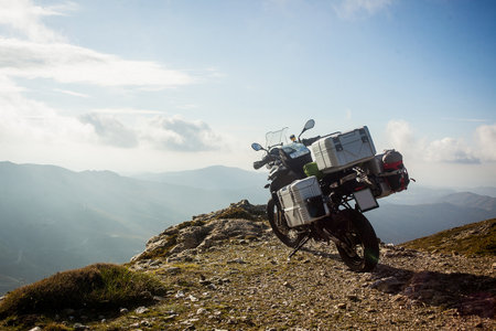Loaded adventure motorcycle with plastic sidecases and topcase on top of the Bruncu Spina mountain on Sardinia, Italy.の写真素材