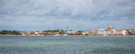 Panorama of the city of Alghero on Sardinia with heavy clouds over the cityscape above the sea.の写真素材