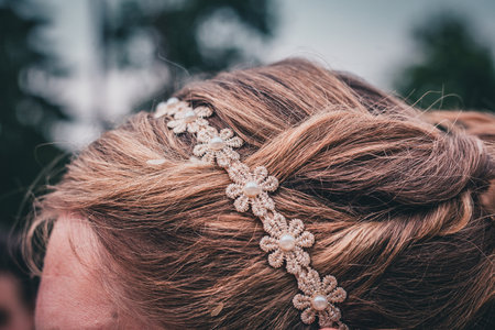Detail of a floral hair accessory on blonde light brown hair.の写真素材