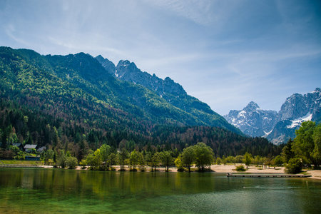 Lake Jasna in Kranjska gora, slovenia, with mountains seen in the background. Beautiful late spring panorama of julian alps above lake Jasna.の写真素材
