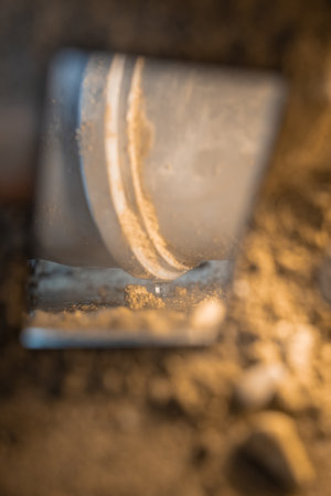 Inspecting an old leaking plastic sewage pipe using a mirror to observe drops of water leaking from the pipe joint.の写真素材