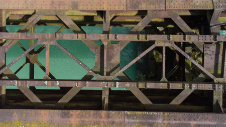 Old deserted and dangerous railway bridge in Dravograd, once important transit path, now forgotten above the Drava river. View from aboveの写真素材