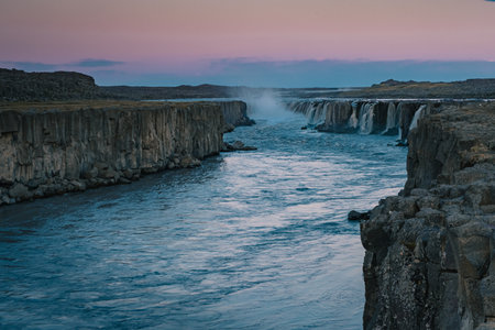 Beautiful Selfoss waterfall in the Dettiffos area, large amount of water falling down making a droplet curtain during summer sunset in rich colors. Nice evening next to a big waterfall.の写真素材