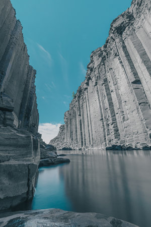 Amazing Studlagil canyon with high basalt columns in Iceland on a summer day. Low perspective viewed directly from the water.の写真素材