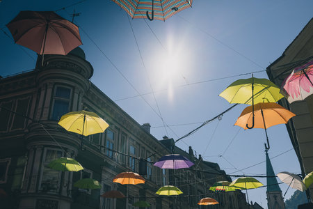 Bunch of umbrellas floating above the streets in Celje.Street decorations in the centre of an old city.の写真素材
