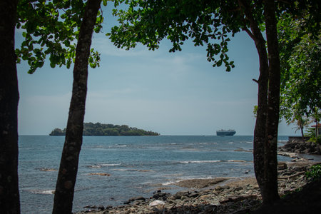 Isla Uvita, a small island in carribean just outside the Puerto Limon city, looking from the city across the bay. Ferry is just about to come in.の写真素材