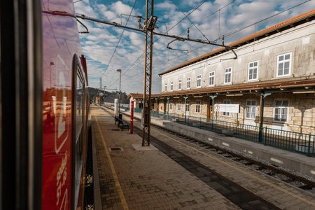 Train station of Hrpelje - Kozina in slovenian istria. View of magnificent big train station made of stone from a red train passing byの写真素材