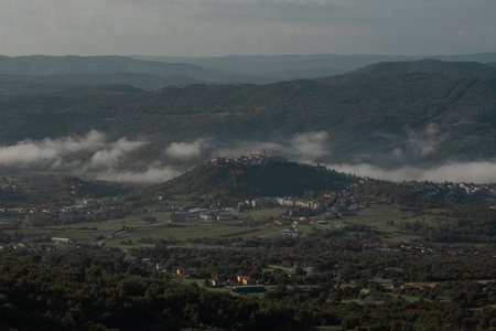 Croatian town of Buzet viewed from above. Medieval picturesque city in istria viewed from the train track up above the city.の写真素材