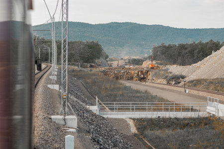 Excavation works at the construction site of second railway track and tunnels in slovenia on the line towards Koper. Construction site around divaca, preparing the embankment to the first tunnelの写真素材