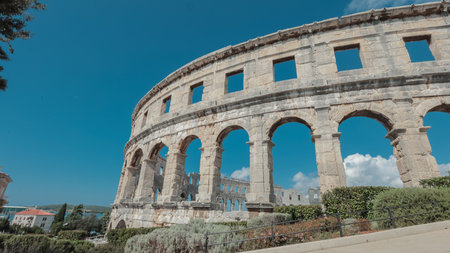 Beautiful colloseum or amphitheatre iin Pula, viewed on a sunny day without clouds. Blue skies above the theatre in pulaの写真素材