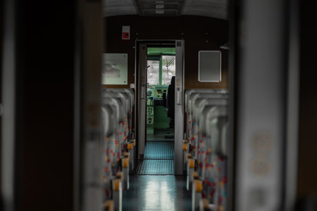 Interior of an old style train looking towards the open drivers cabin. Vintage looking seat covers and leather headrest...の写真素材