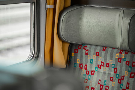 Interior of an old style train, vintage looking seat covers and leather headrest, old style train, but comfortable....の写真素材