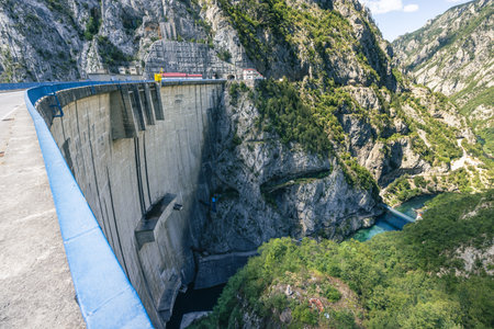 Mratinje hydroelectric power dam in the narrow gorge of Piva river in Montenegro or Crna Gora. Wide panoramic view of deep gorge behind the high concrete dam...の写真素材