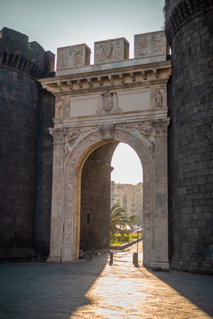 Beautiful evening photo with strong sunshine backlight of Porta Capuana entrance gate to the old town of Napoli old town. Magnificent roman gate in Naples..の写真素材