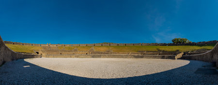 Panoramic view of amphitheatre in pompeii. Collossal view of anfiteatro between the ruins of pompei city close to Naples in italy on a sunny autumn day.の写真素材