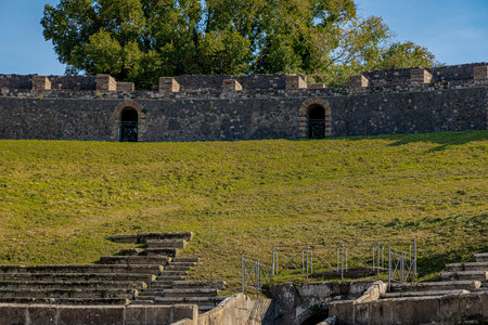 Side view of amphitheatre in Pompeii. Colossal view of anfiteatro between the ruins of Pompeii city close to Naples in Italy on a sunny autumn dayの写真素材
