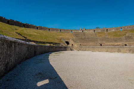 Panorama view of amphitheatre in pompeii. Collossal view of anfiteatro between the ruins of pompei city close to Naples in italy on a sunny autumn day....の写真素材