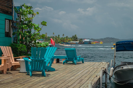 Beach chairs for resting at a pier or dock at beautiful destination of Bocas del Toro, Panama....