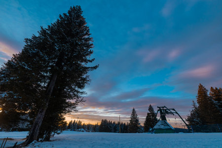 Ski lift on Rogla, ski resort on pohorje on colorful winter evening. Evening colors and old and vintage ski lift, anchors.の写真素材