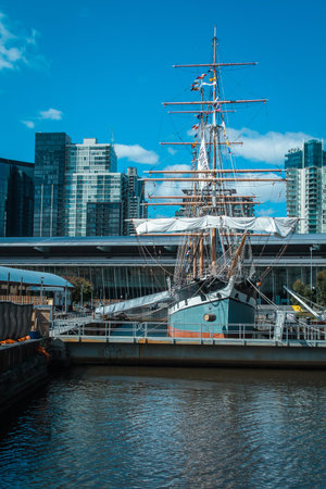 Sailboat moored in docklands district in the Melbourne, Australia. Marina, sea and roads in this part of the city on a sunny dayの写真素材