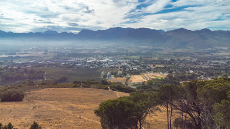 Drone panorama down from paarl mountain toward Paarl city with brown grass at the end of summer and some trees.の写真素材
