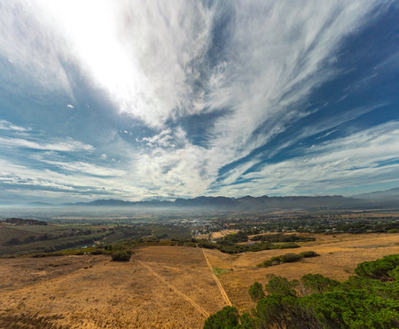 Wide epic drone panorama down from paarl mountain toward Paarl city with brown grass at the end of summer and some trees.の写真素材