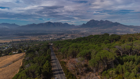 Drone panorama down from paarl mountain toward eastern part of paarl city with industrial zone close by and Franschoek in the backgroundの写真素材