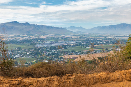 Looking down from paarl mountain toward eastern part of paarl city with industrial zone close by and Franschoek in the backgroundの写真素材