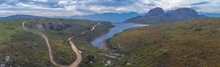 Aerial drone panorama of Paarl mountain nature reserve above the city of Paarl in South Africa. Cloudy day with visible lake and fynbos vegetation dominated by massive rounded granite rock formationsの写真素材